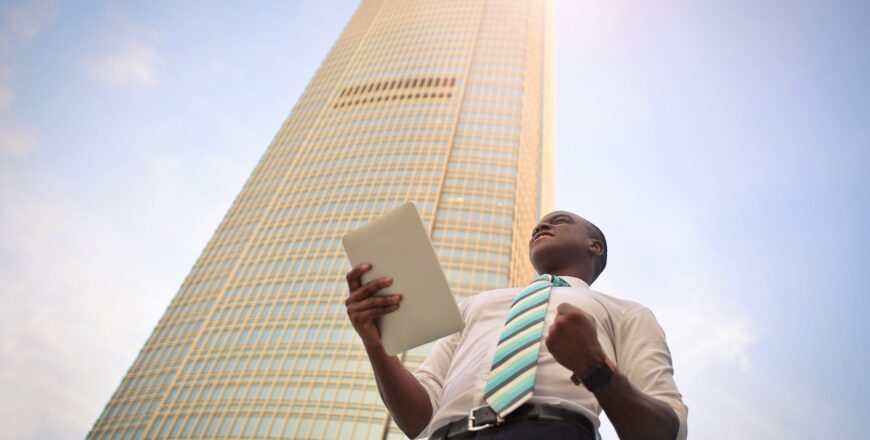 man standing near high-rise building