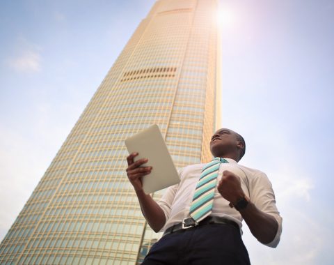 man standing near high-rise building